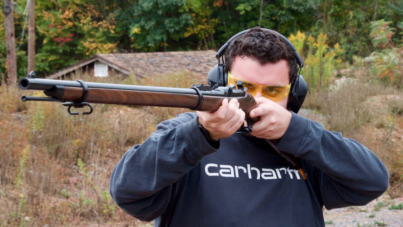 Man shooting a Springfield 1873 Trapdoor reproduction rifle