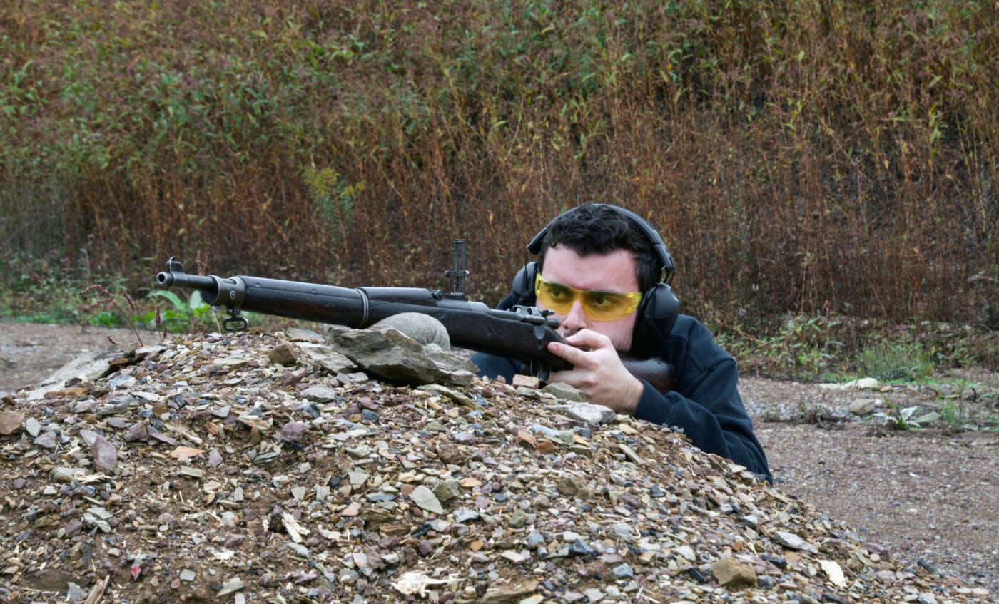 Man shooting a Springfield M1903 rifle