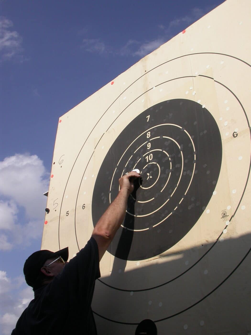 Man examining target during a long range competition target shooting event