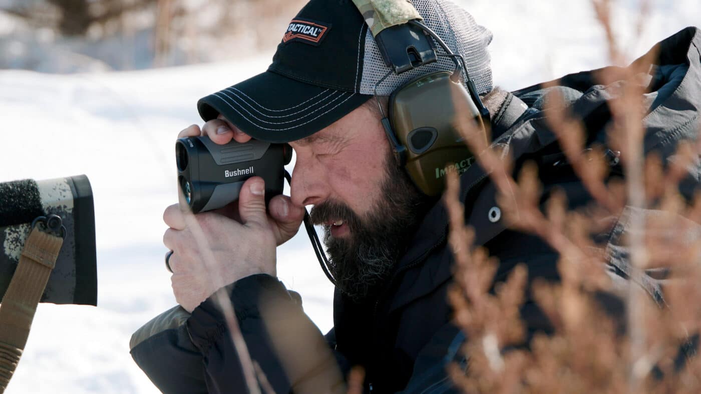 Man using Bushnell Nitro 1800 rangefinder