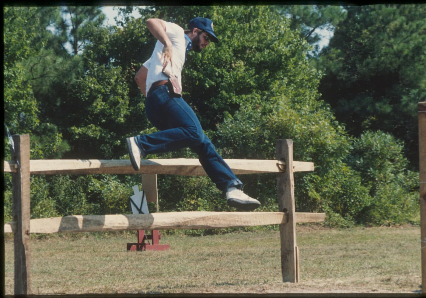 Rob Leatham jumping a fence in the 1983 IPSC World Shoot