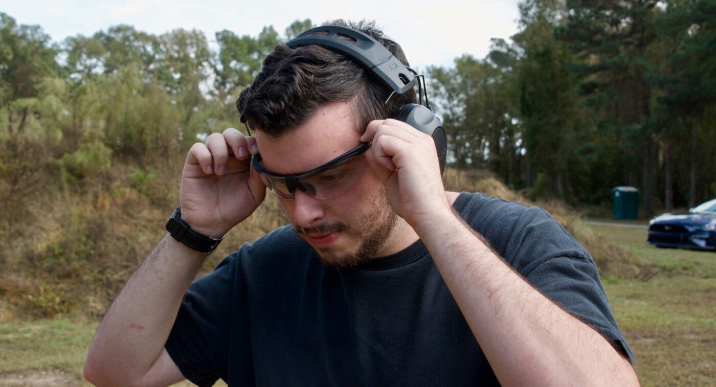 Man putting on eye protection for shooting