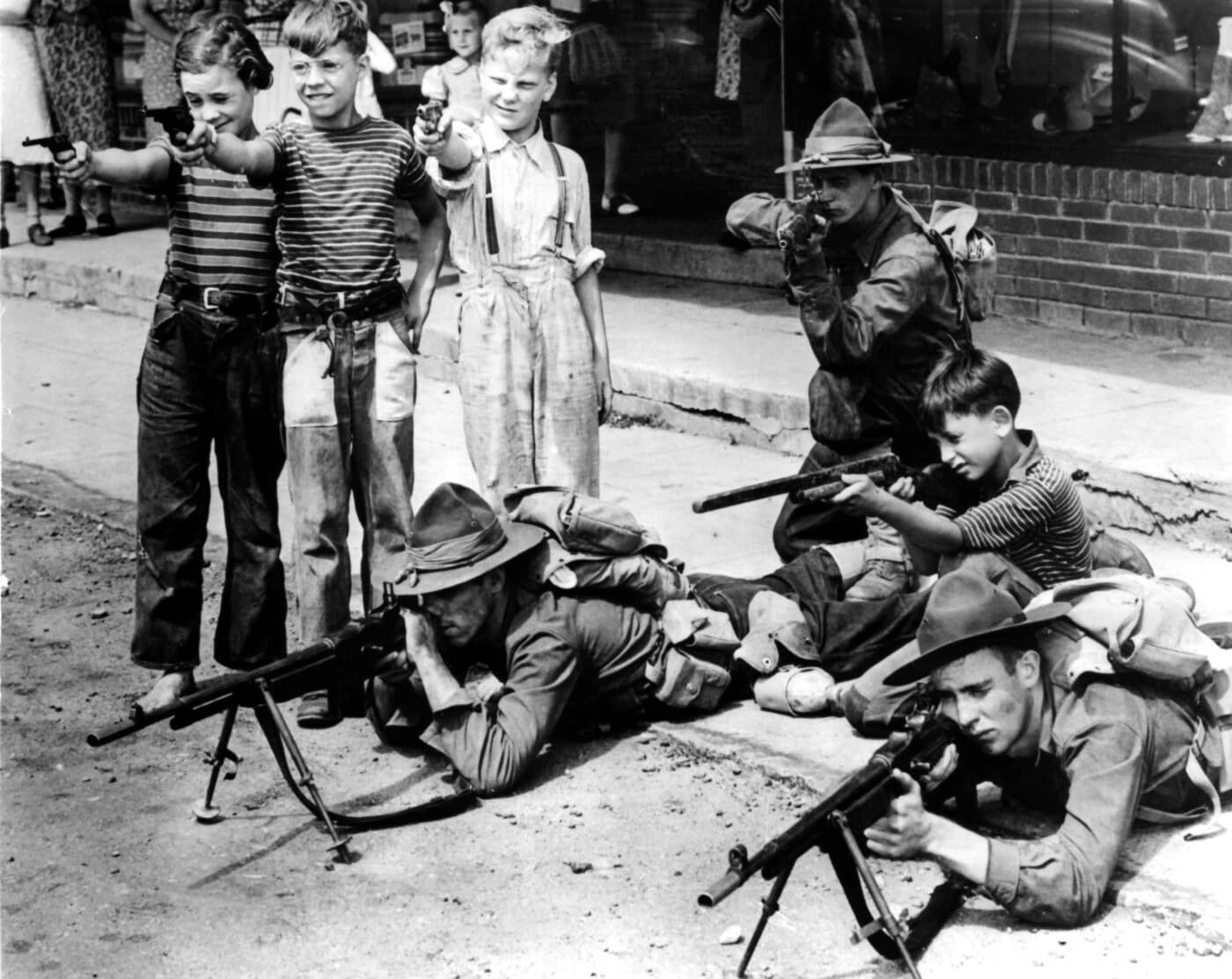 U.S. soldiers with M1918 BAR with children standing next to them with toy guns