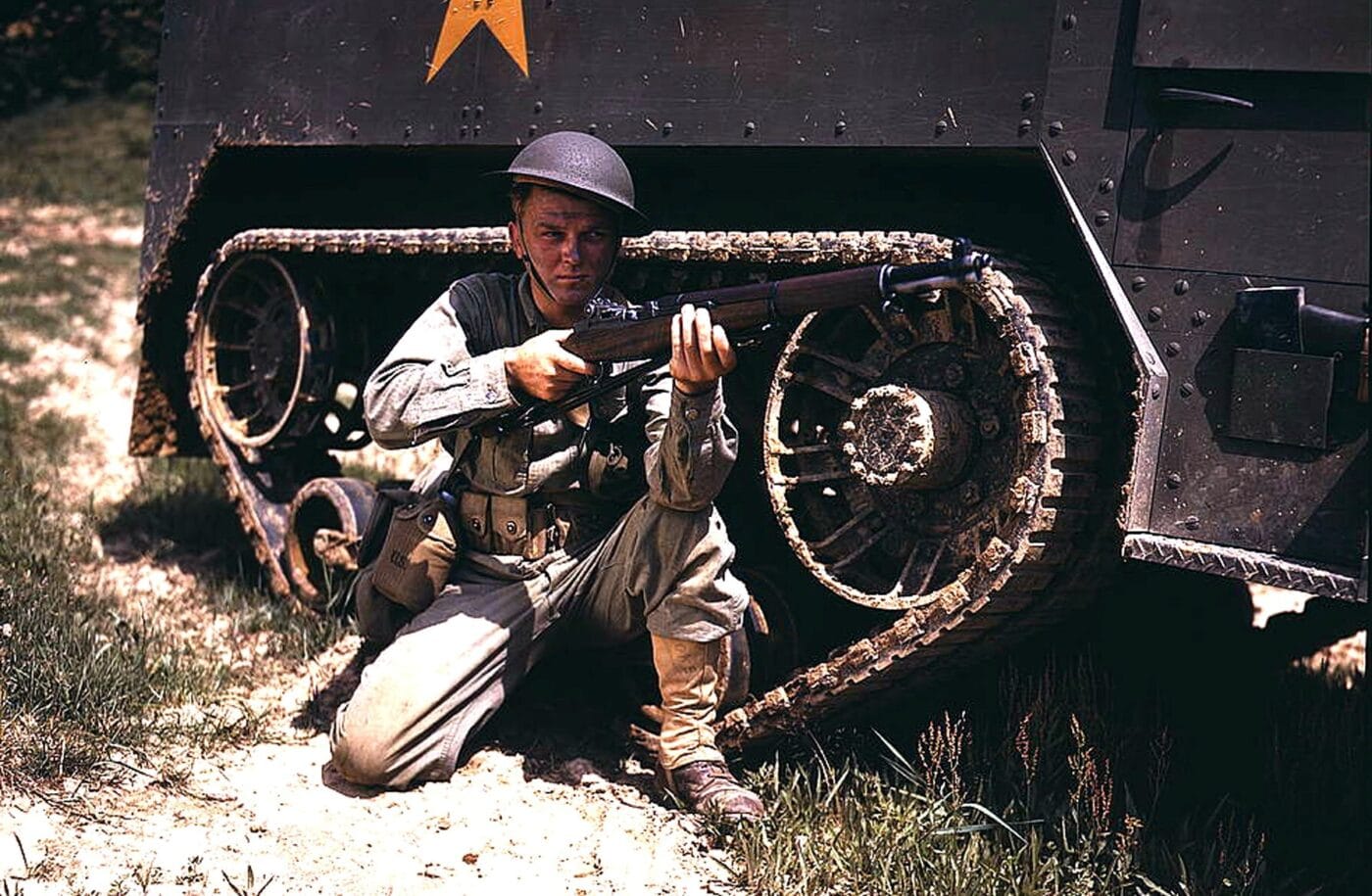 Soldier next to an M1 with halftrack