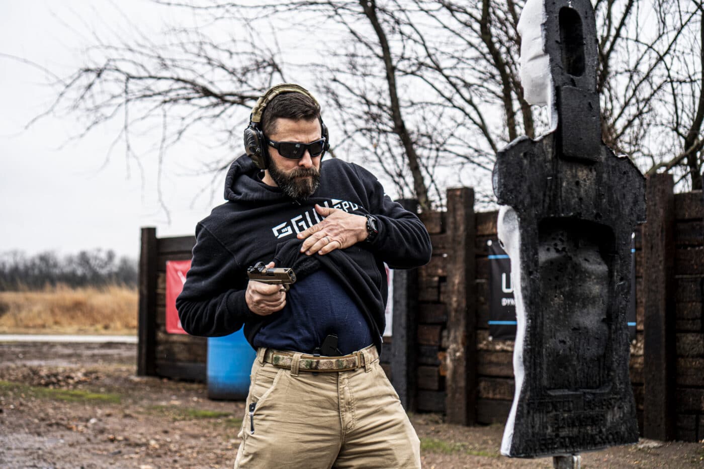 Man drawing pistol from the Blue Alpha belt