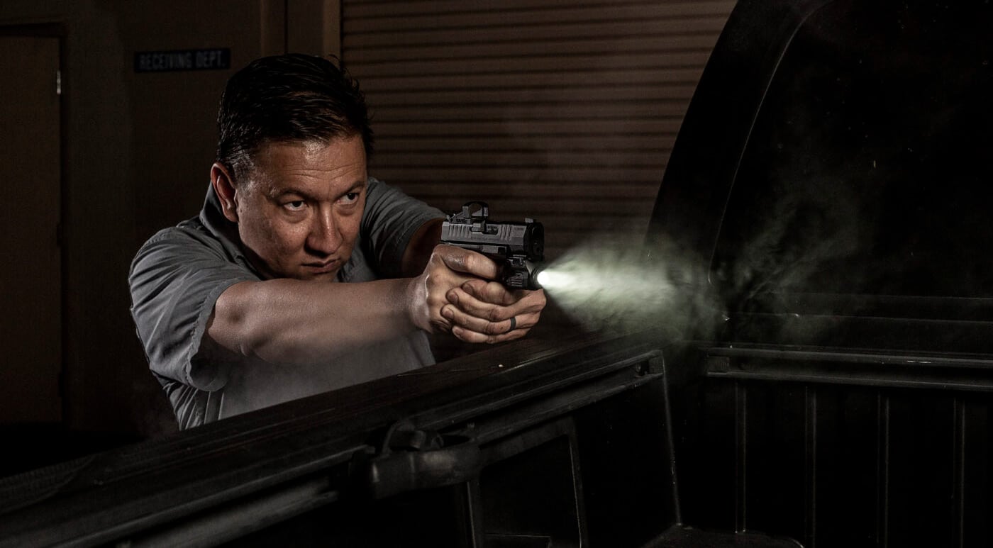 Man training with weaponlight on pistol