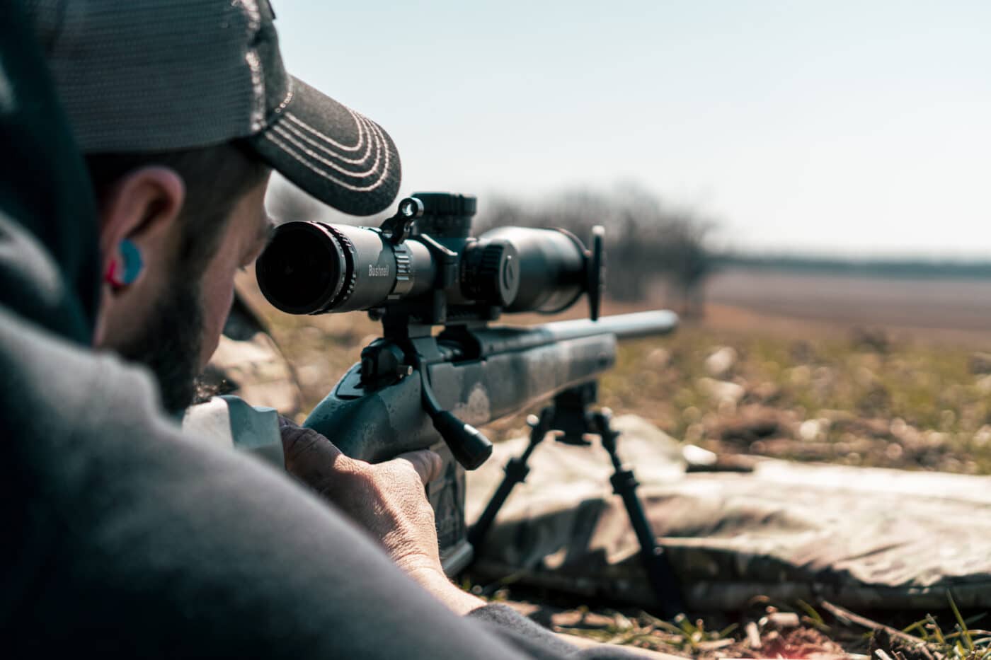 Man shooting a moving target with a scoped Waypoint rifle