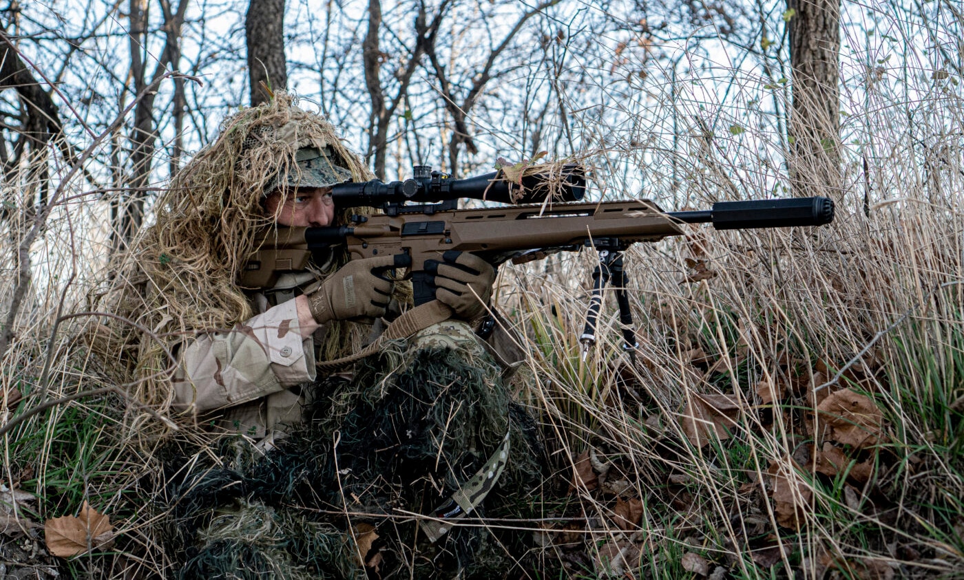 Man in camo hunting with Springfield SAINT Edge ATC rifle