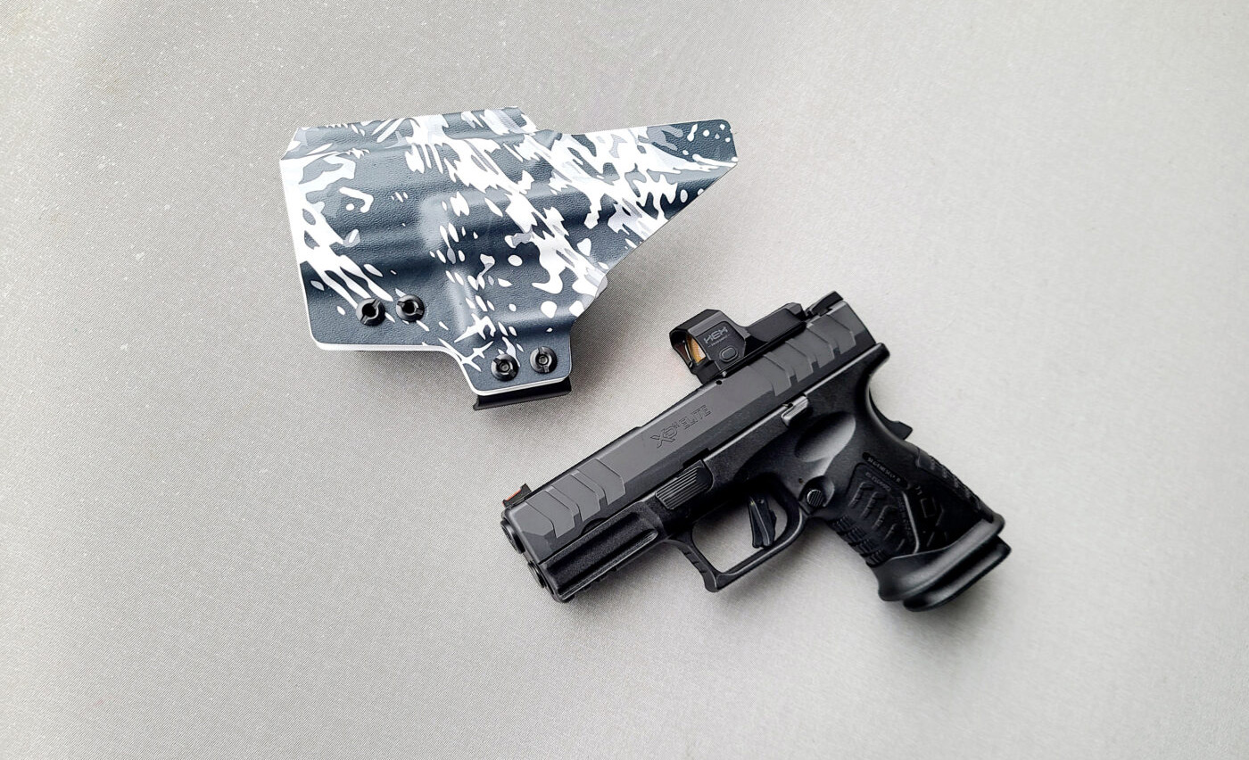 QVO Tactical IWB holster next to a Springfield XD-M Elite 3.8" Compact OSP 10mm pistol