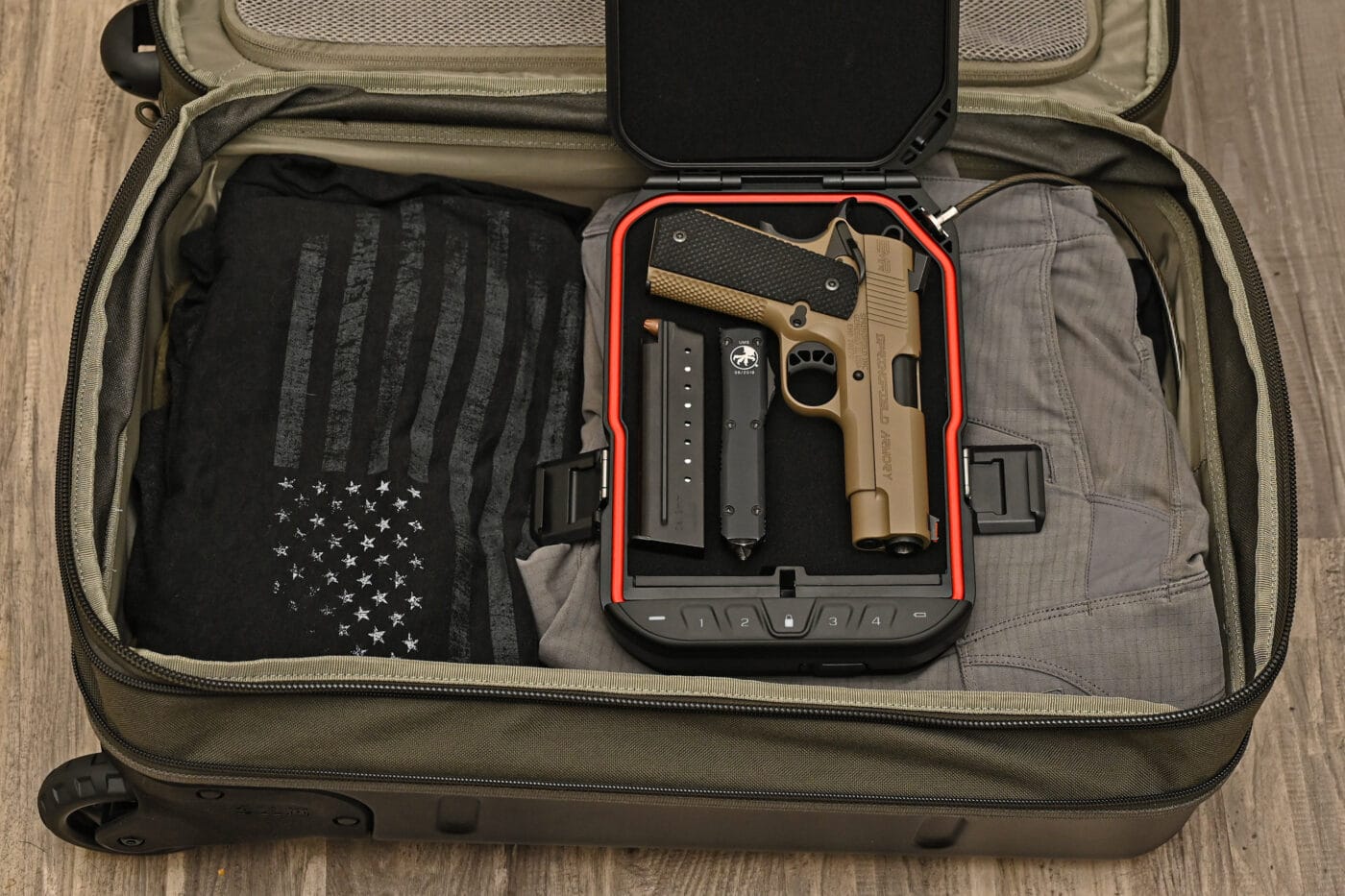 Vaultek LifePod open in luggage with pistol in it