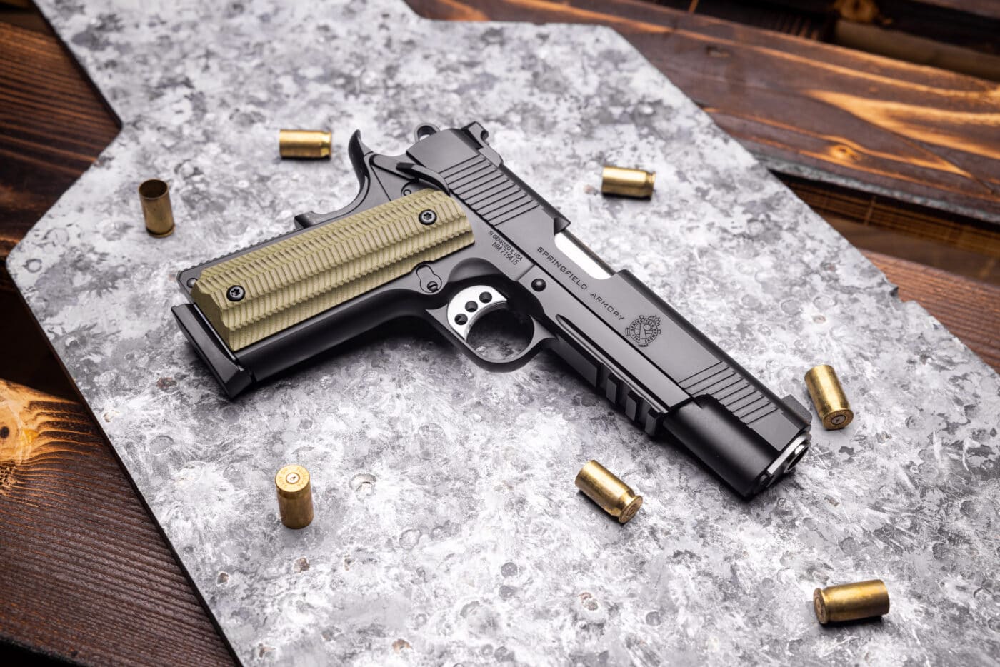 Springfield Armory .45 ACP Operator 1911 pistol on a table next to ammo cases