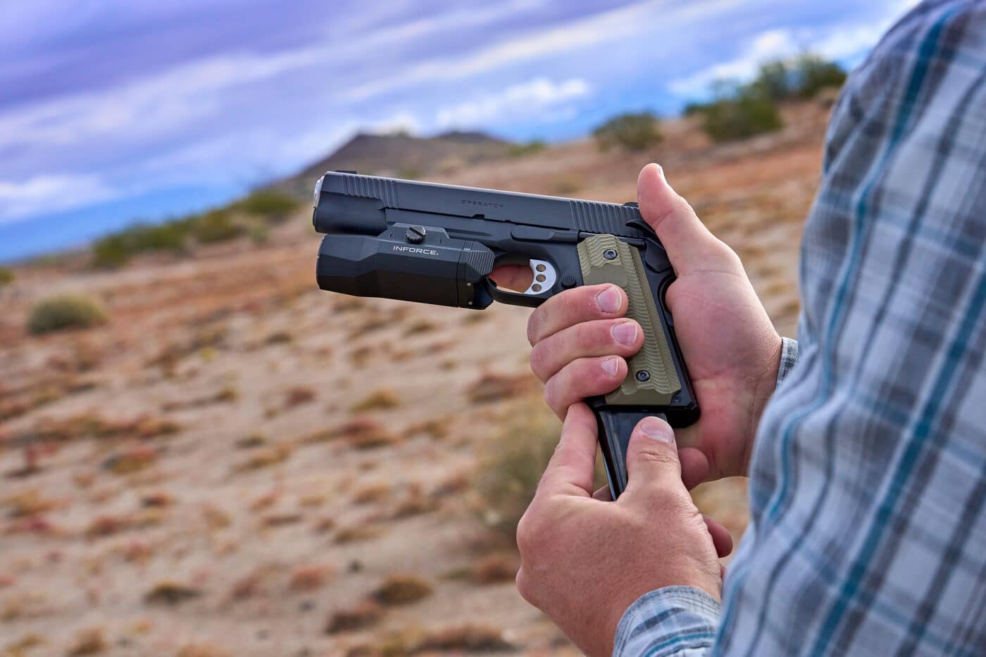 Man holding full size 1911 with rail