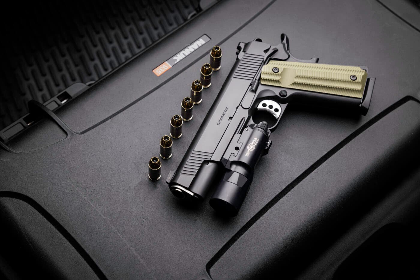 Springfield Armory Operator 1911 pistol with light next to ammo