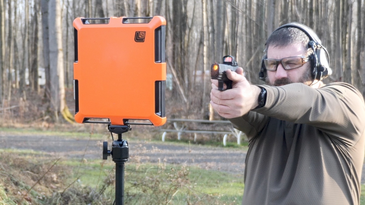 Man shooting Springfield Armory XD-M Elite Compact .45 ACP pistol during range testing