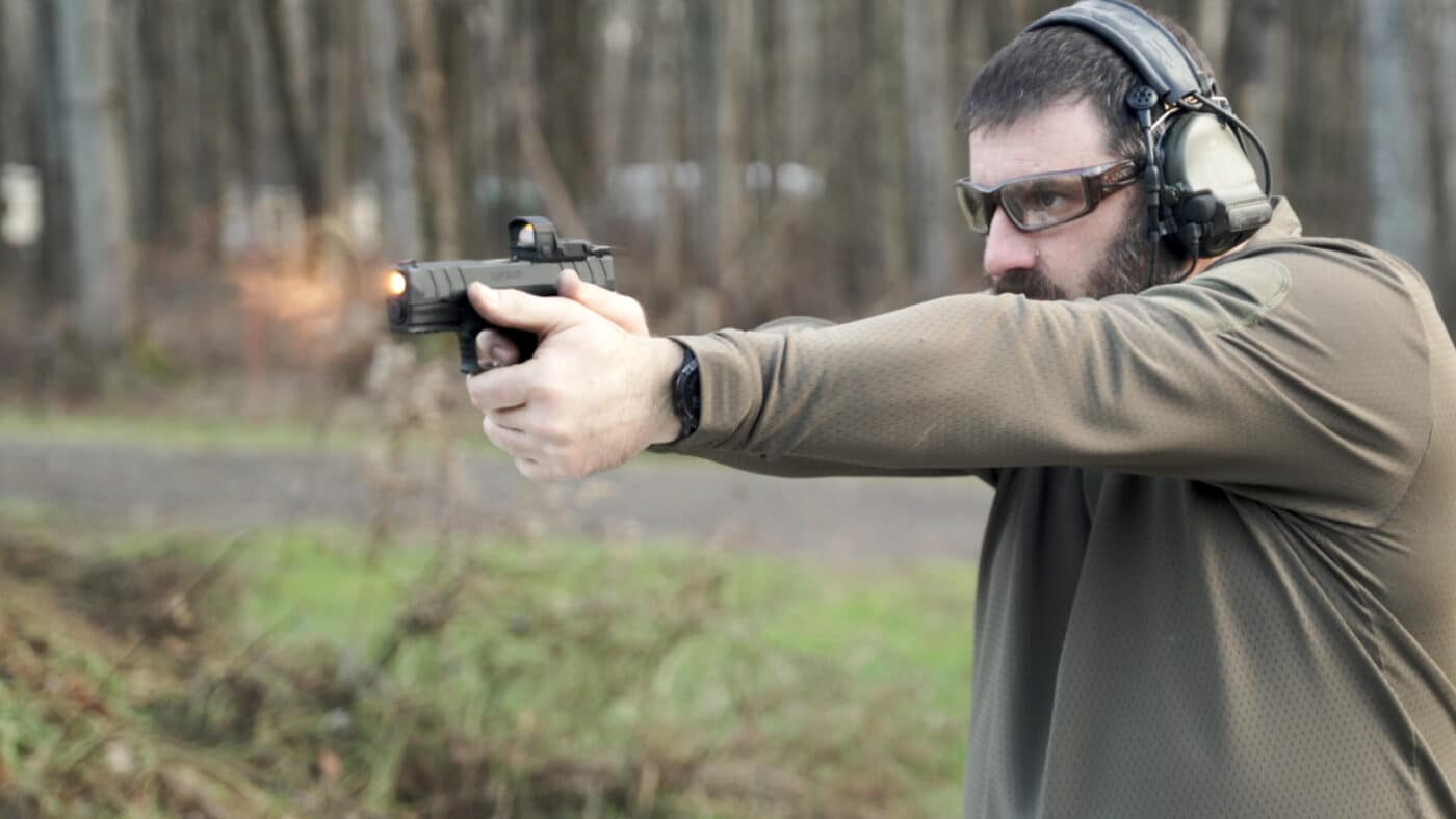 Man shooting the XD-M Elite 3.8" Compact OSP .45 ACP pistol on the range