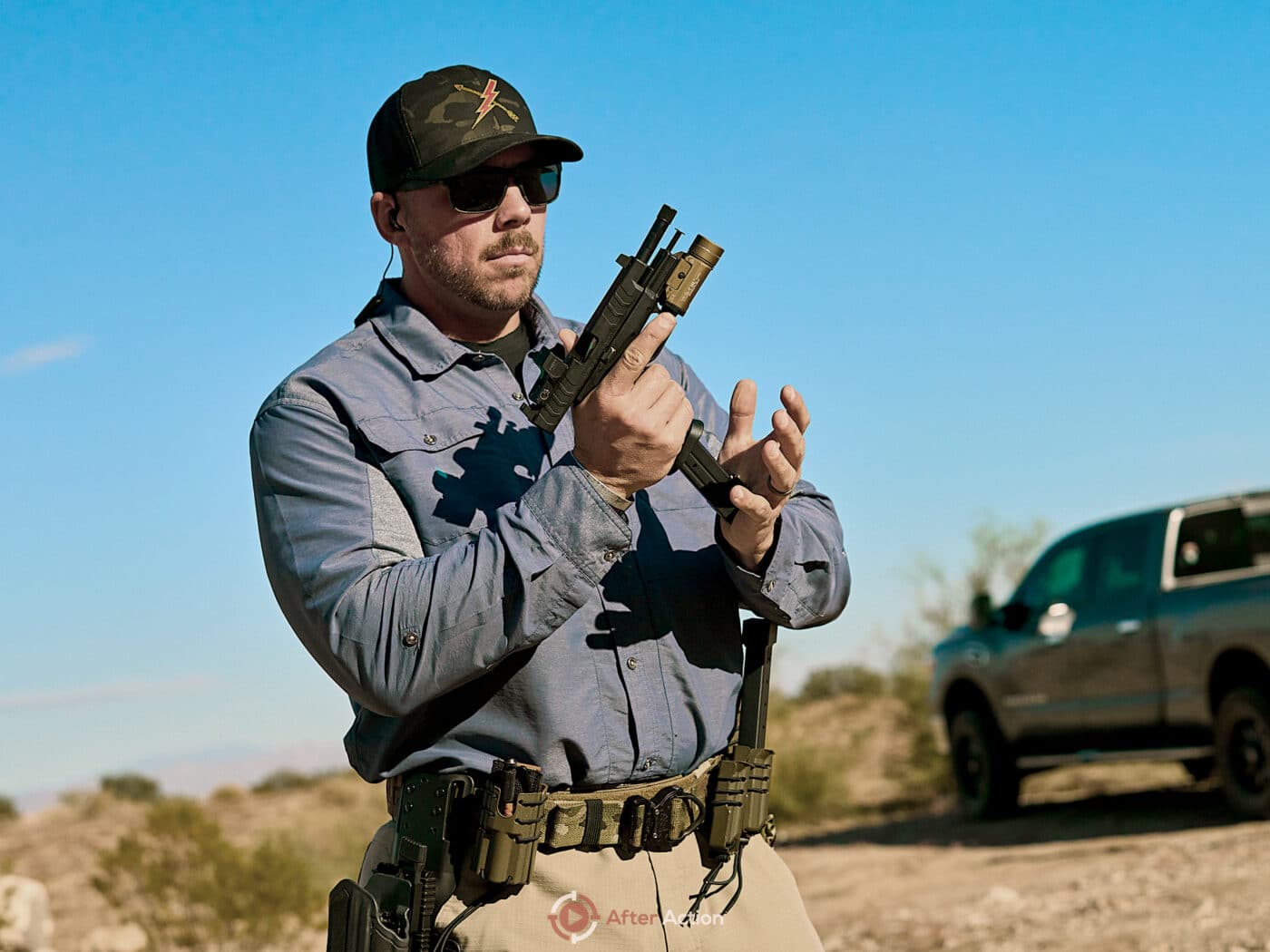 Man loading pistol with highest capacity 9mm magazine for XD-M