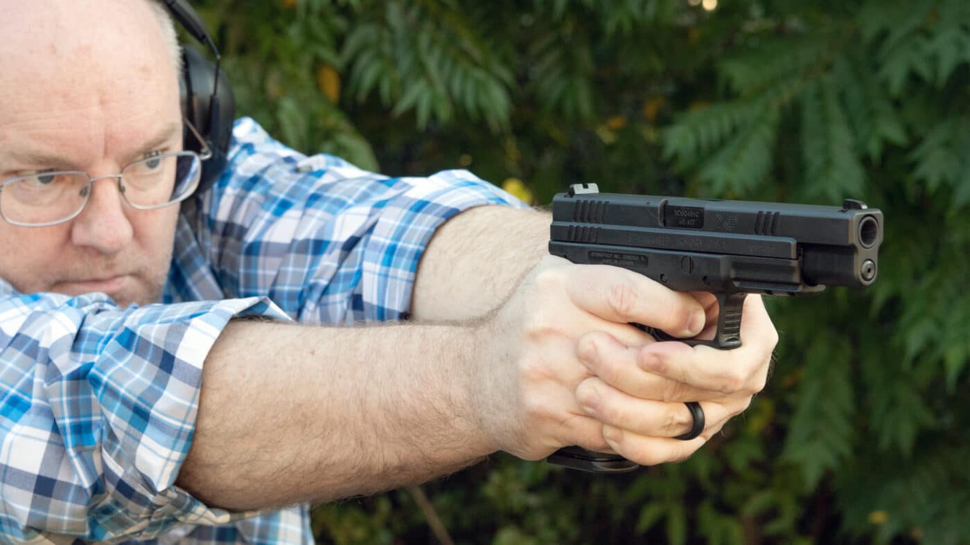 Man shooting the Springfield XD Tactical .45 ACP pistol