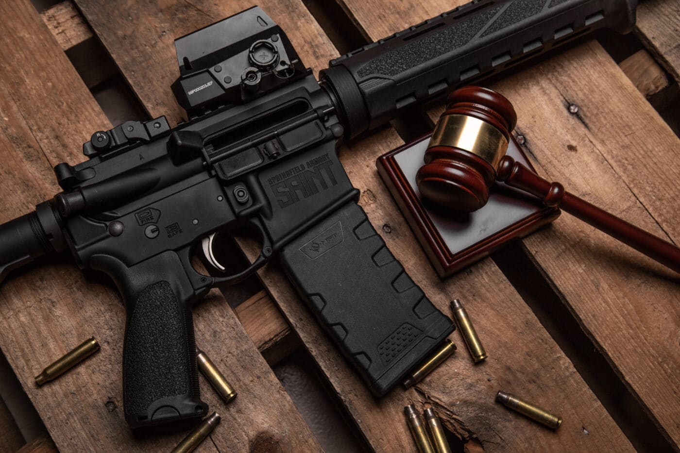 AR-15 rifle next to gavel