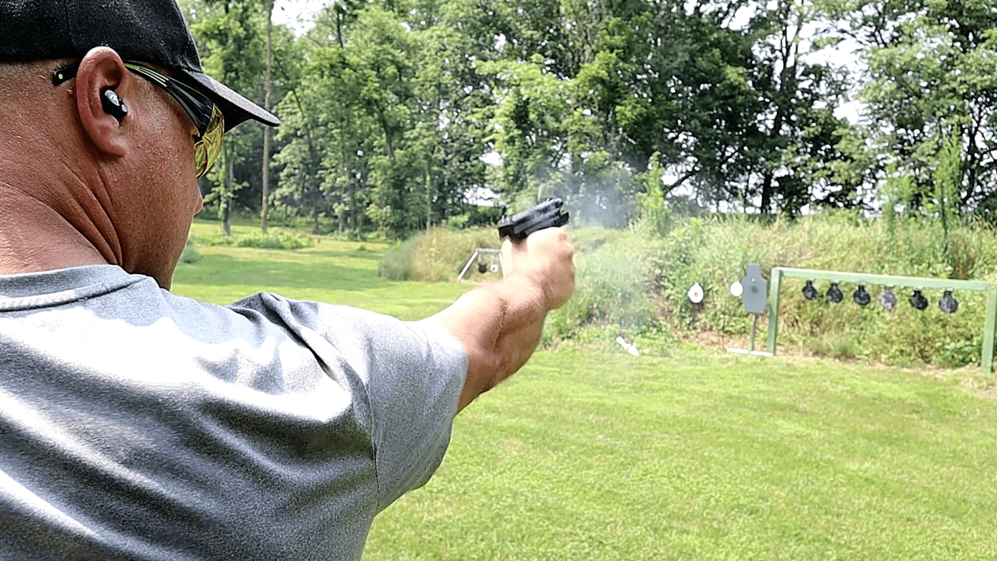 Man demonstrating recoil of .40 pistol shot one handed
