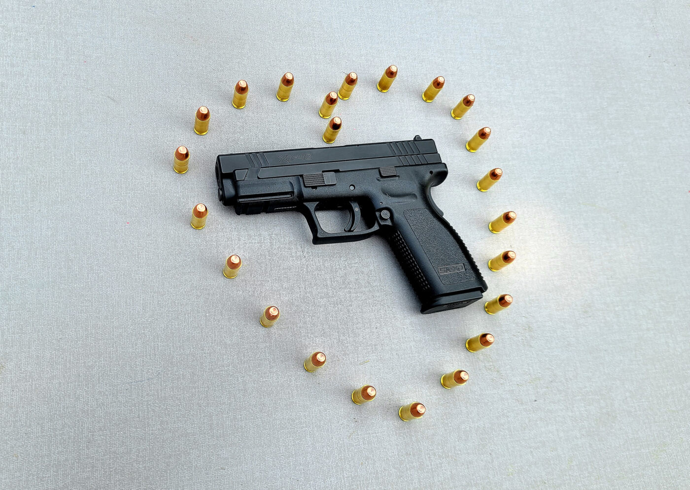 Ammo forming a heart shape around an XD pistol