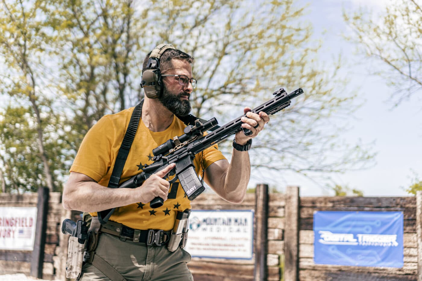 Man holding rifle in muzzle up ready position