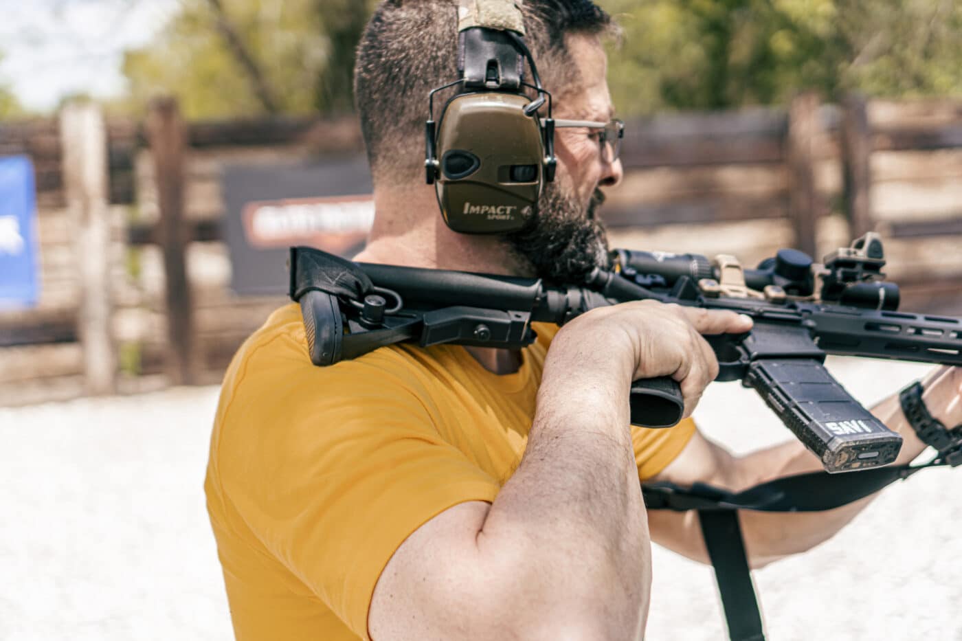 Man holding rifle in an over the shoulder ready position