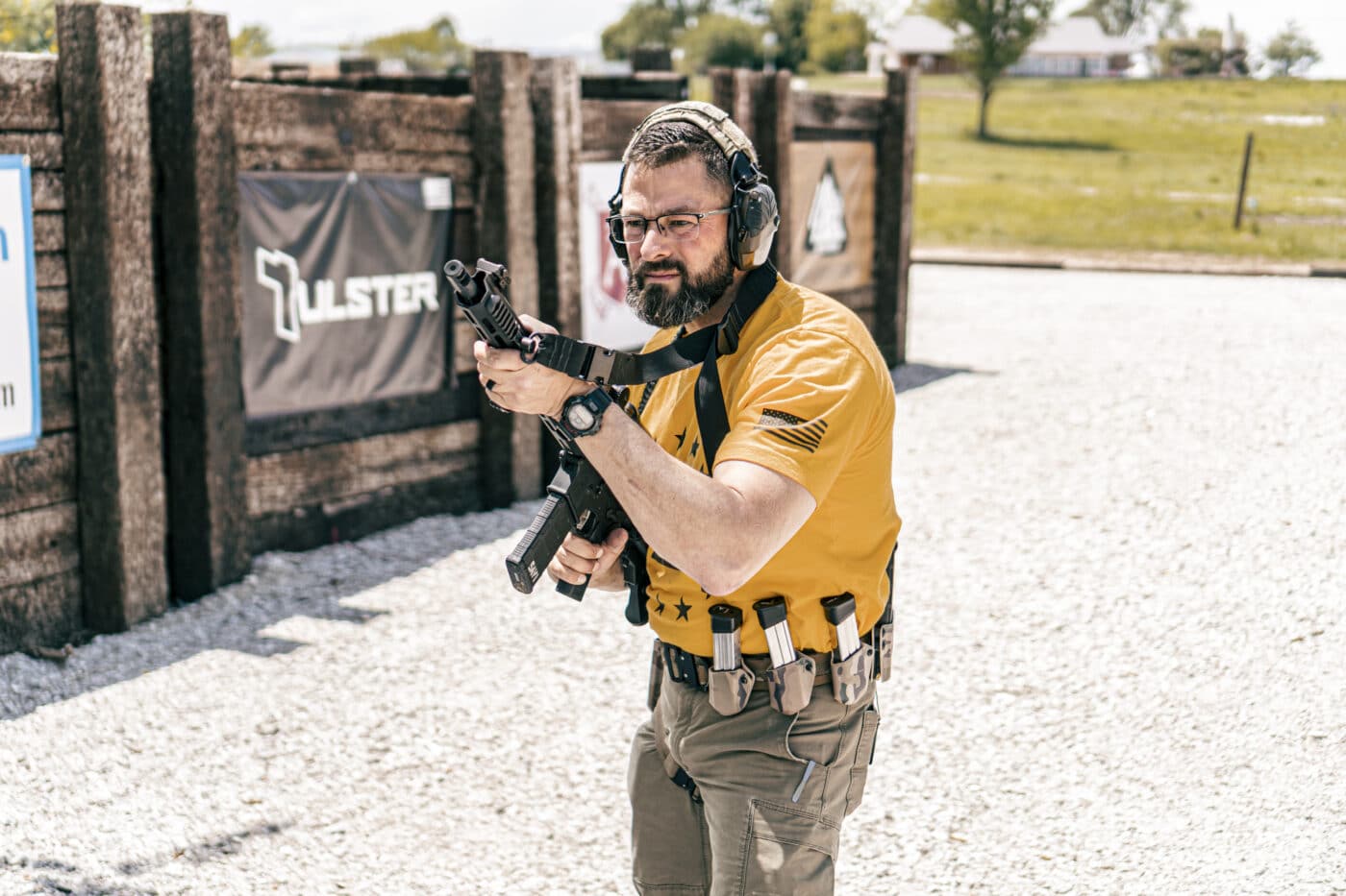 Man holding rifle in muzzle up ready position