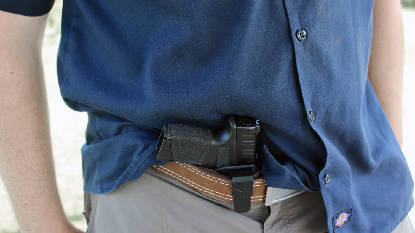 Man demonstrating appendix carry of Hellcat pistol