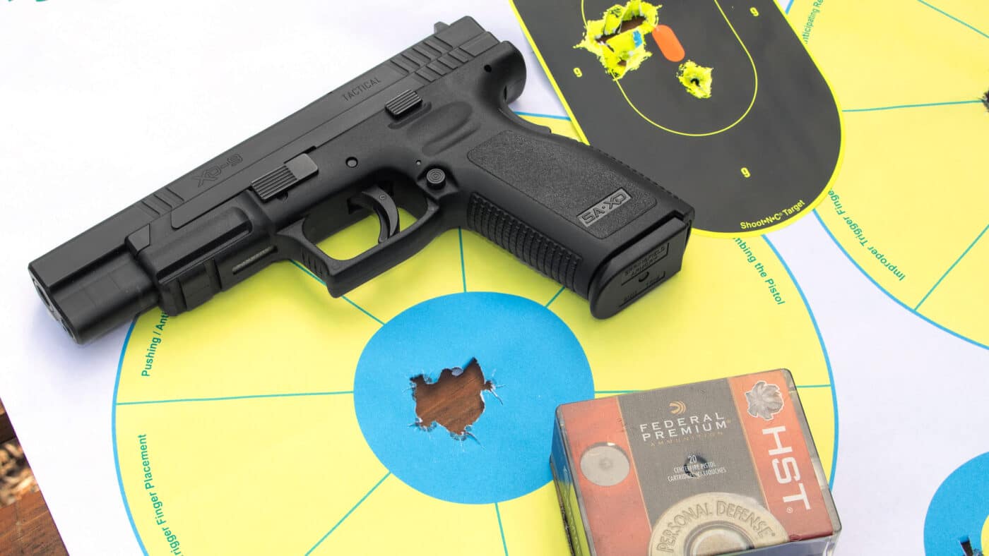 Springfield Armory XD Tactical 9mm pistol on top of test targets