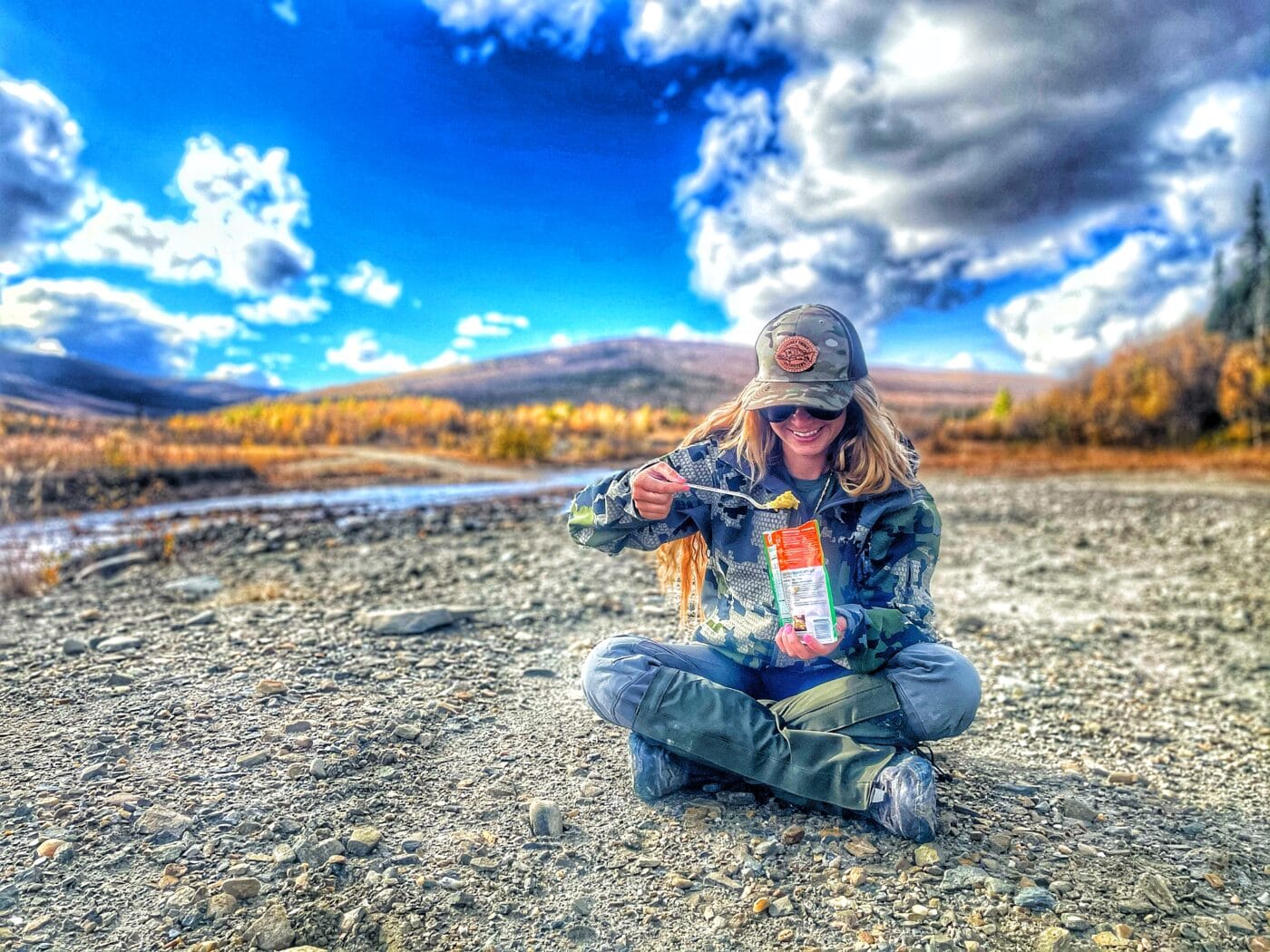 Woman eating on the trail in Alaska
