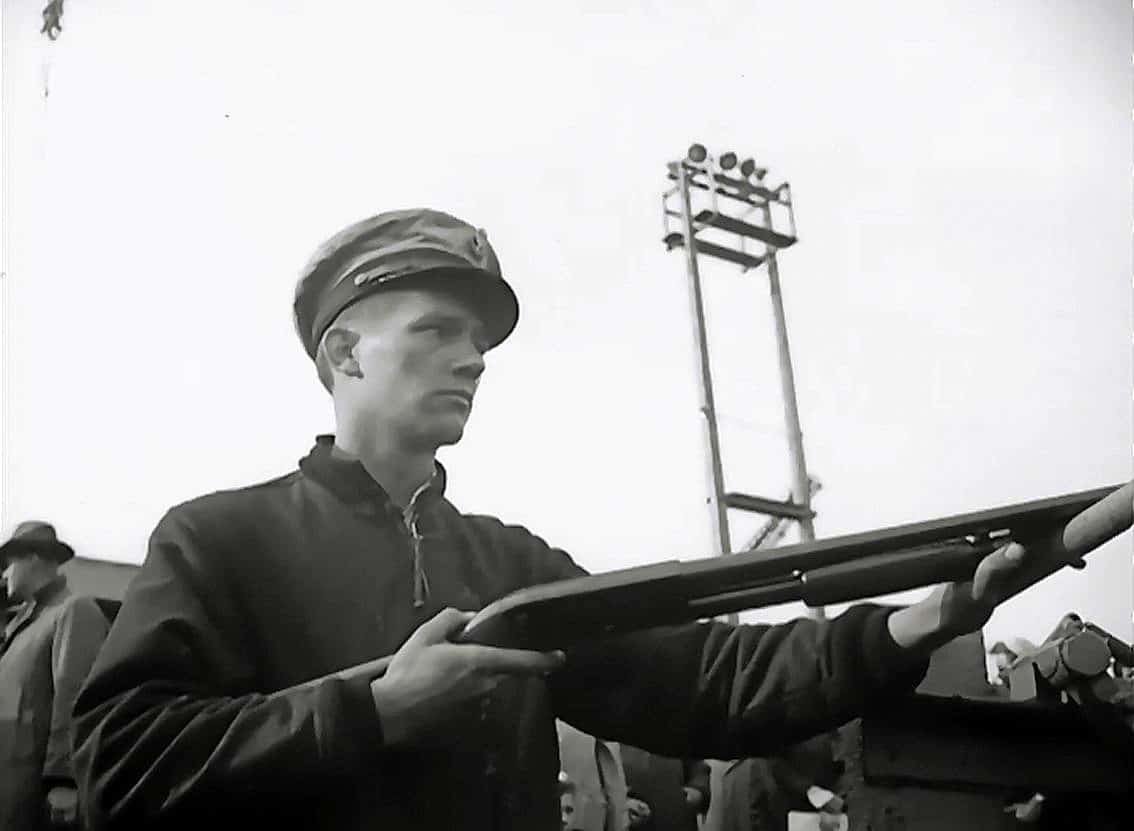 A Coast Guardsman watches over captured U-boatmen with an Ithaca Model 37 12-gauge shotgun