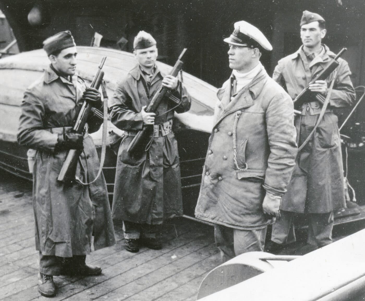 US Marine guards armed with Reising Model 50 SMGs guard U-234’s Captain Fehler