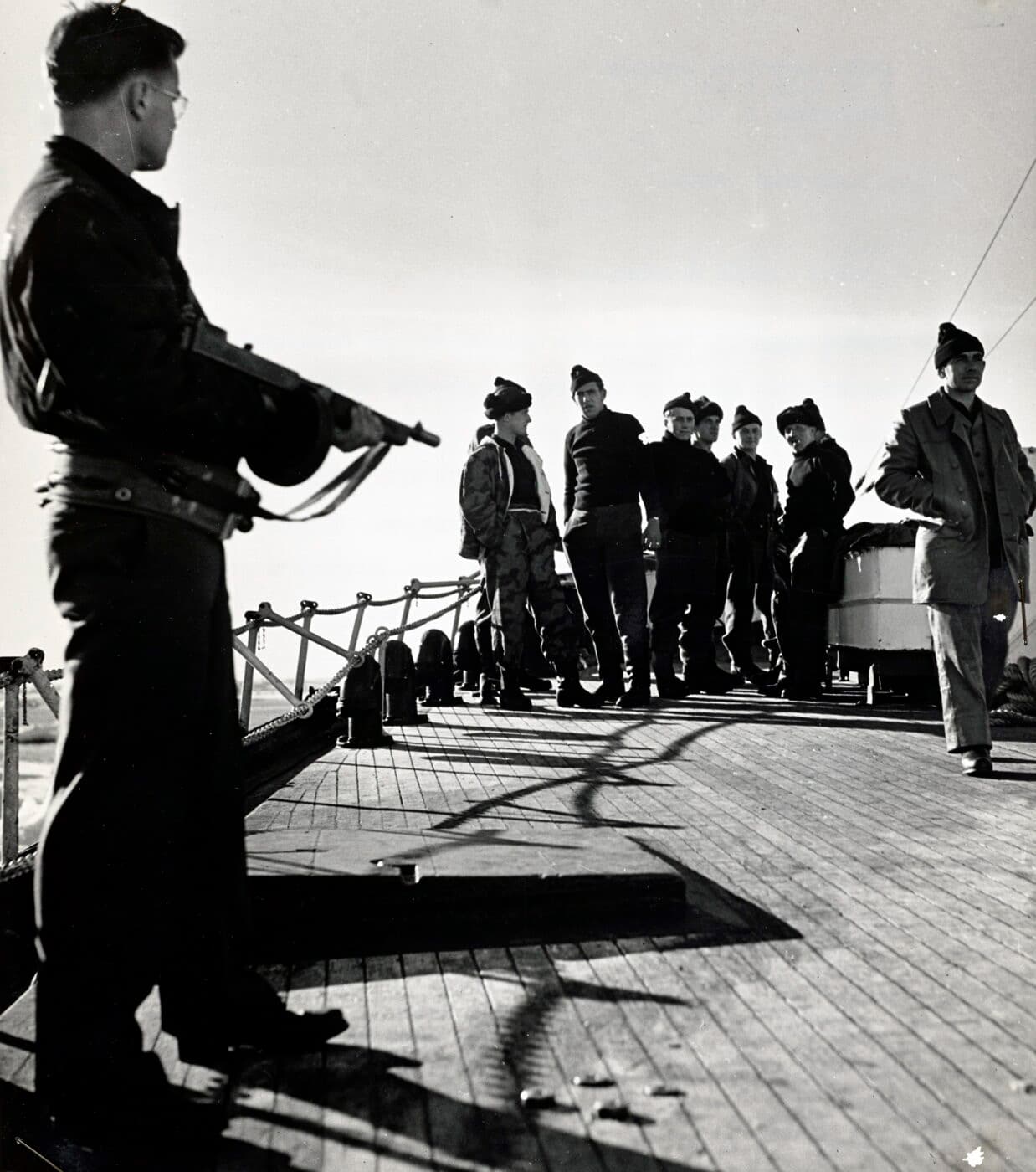 U.S. Coast Guardsman covers U-boatmen with an M1928 Thompson SMG equipped with a 50-round drum magazine