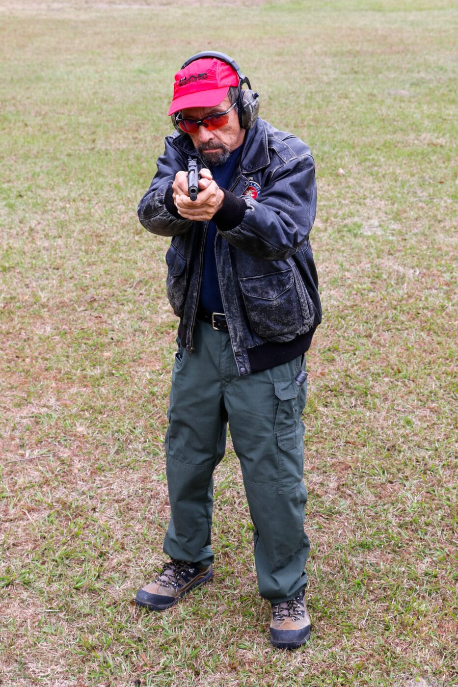 Massad Ayoob shooting a 1911 in a Weaver stance