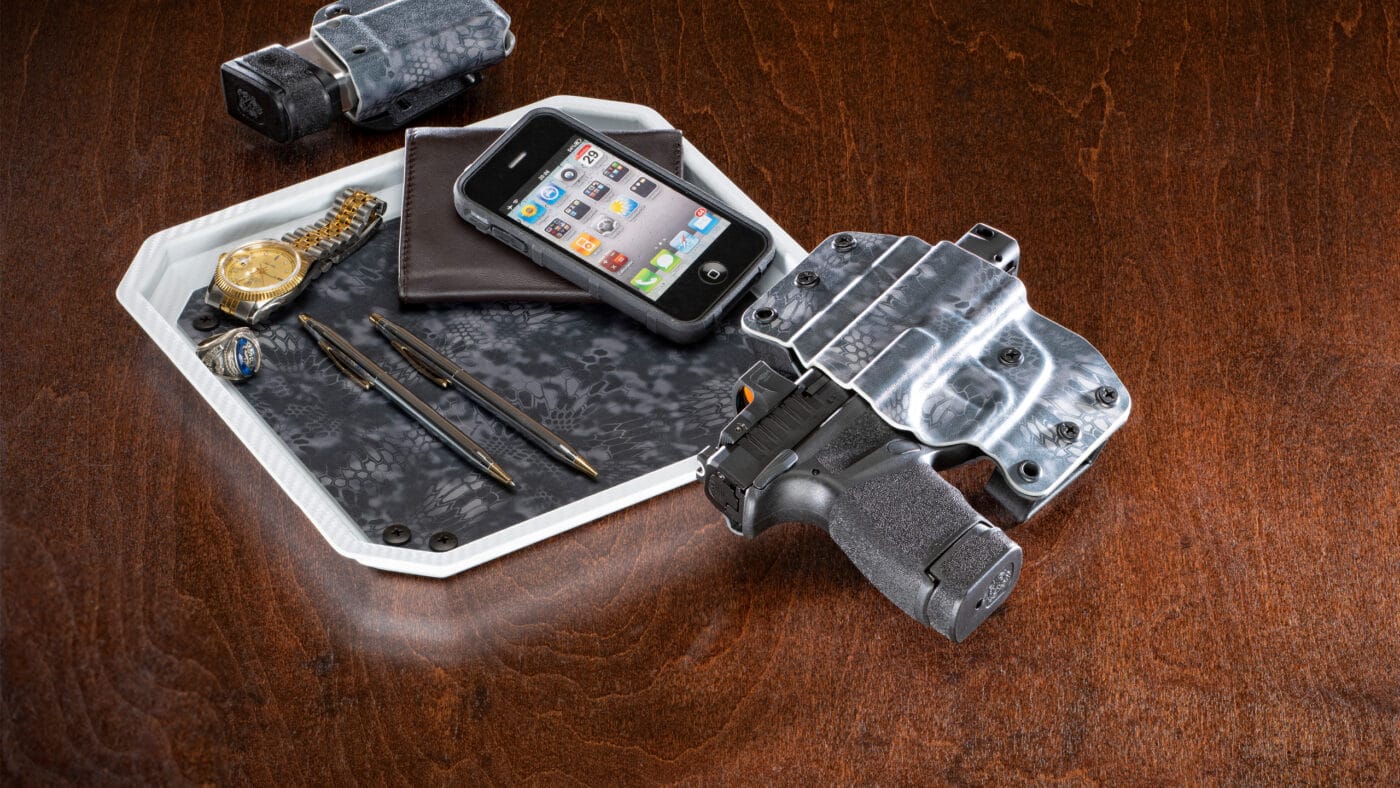 Blackhawk custom holster with Hellcat pistol in it, next to custom Blackhawk dump tray