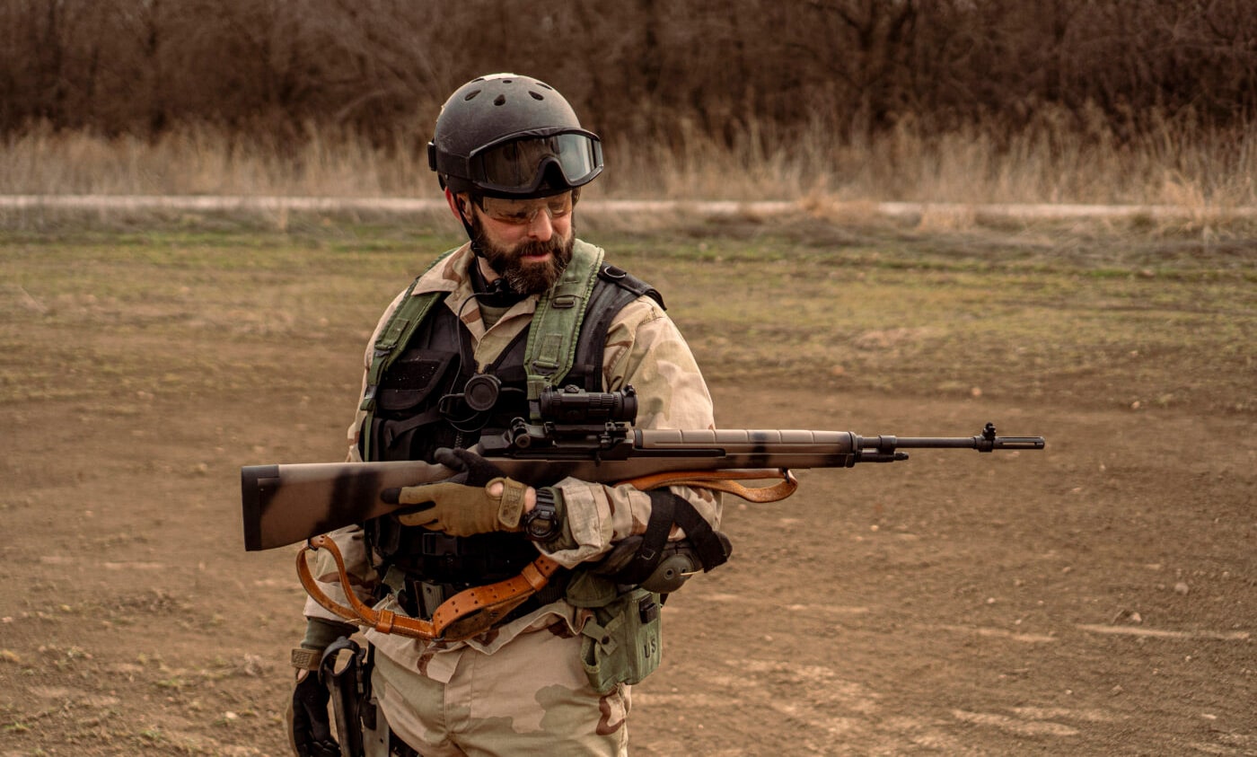 Man holding M1A rifle customized to look very similar to the rifle in the movie Black Hawk Down