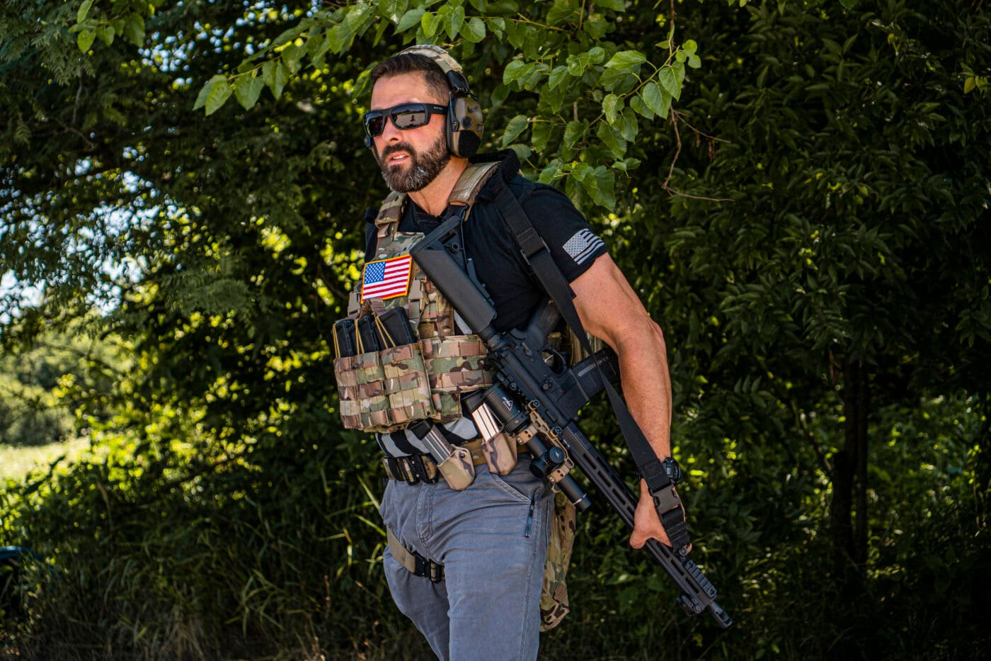 Man using a sling to transition from rifle to pistol