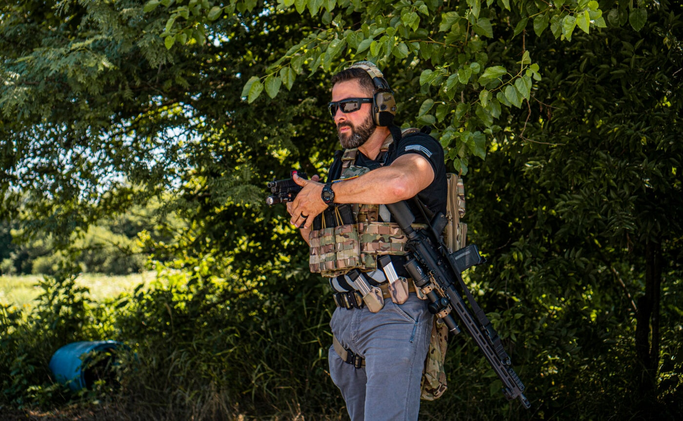 Man showing how to fit a rifle sling to your body