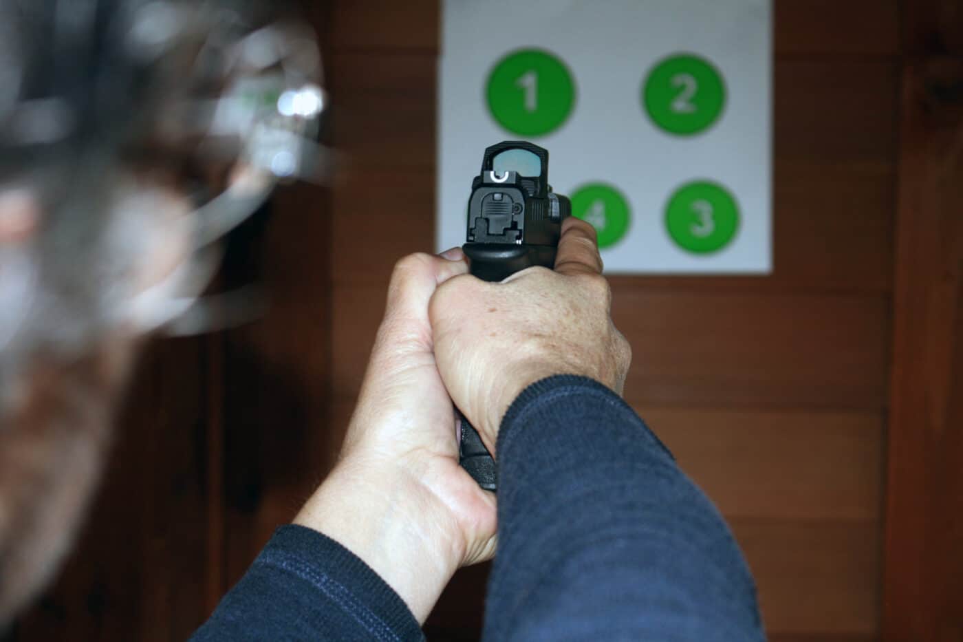 Man doing dry fire practice with red dot sight to help improve shooting skill