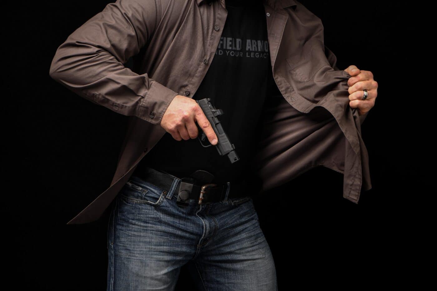 Man drawing a handgun from concealment