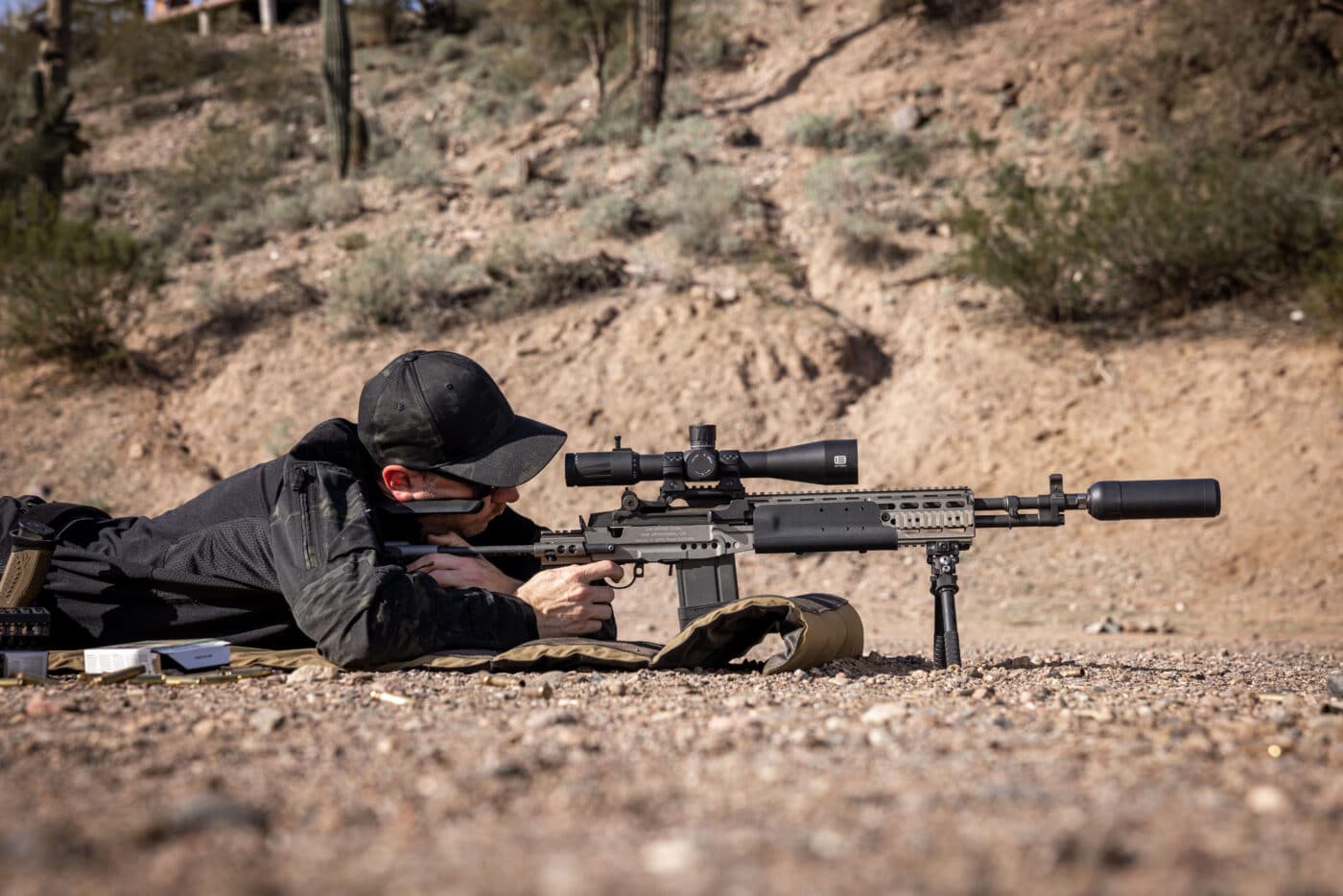 Man shooting the M1A prone with an X2 Dev Group Orion-X suppressor attached