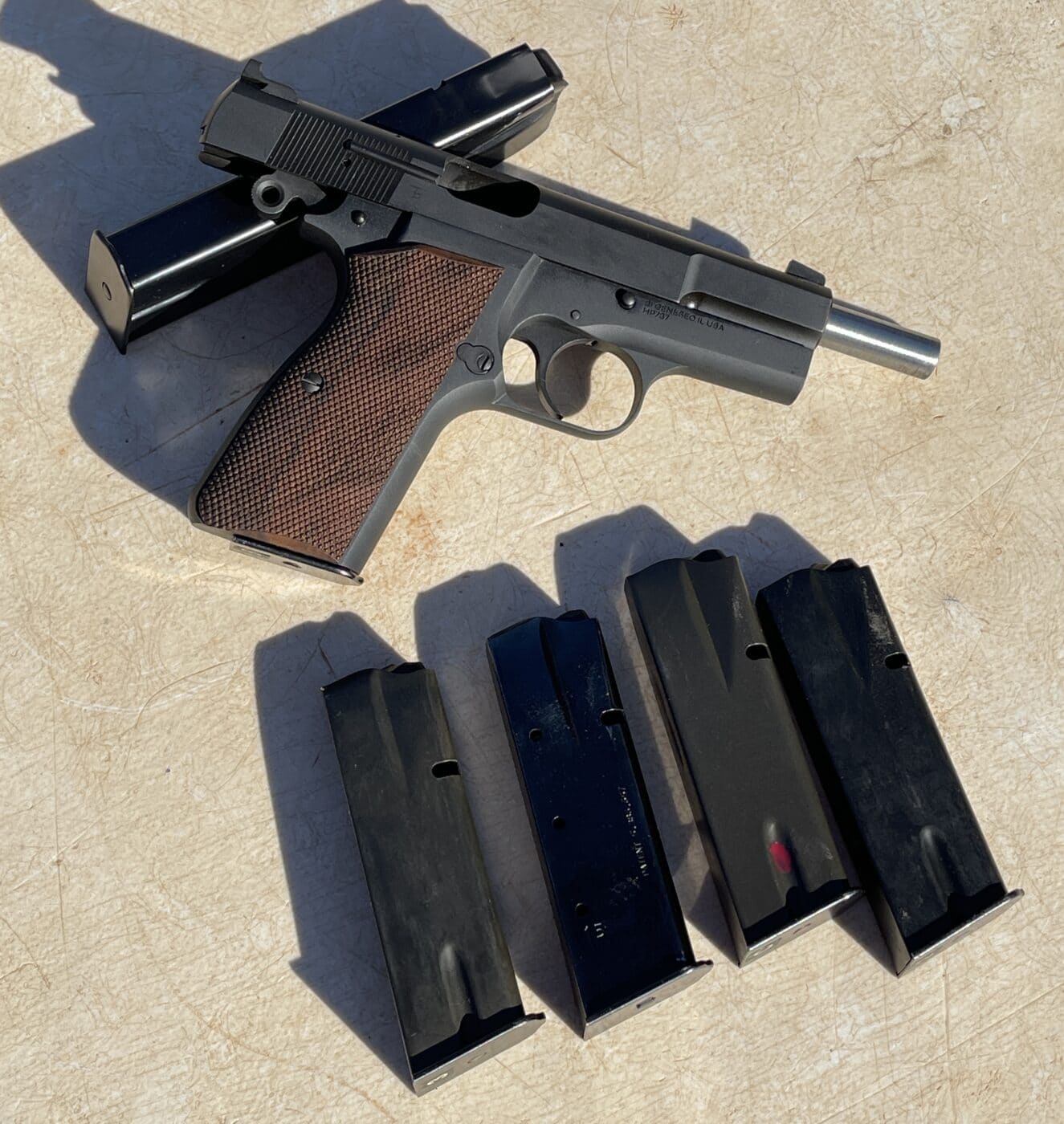 Springfield SA-35 pistol with magazines on a table