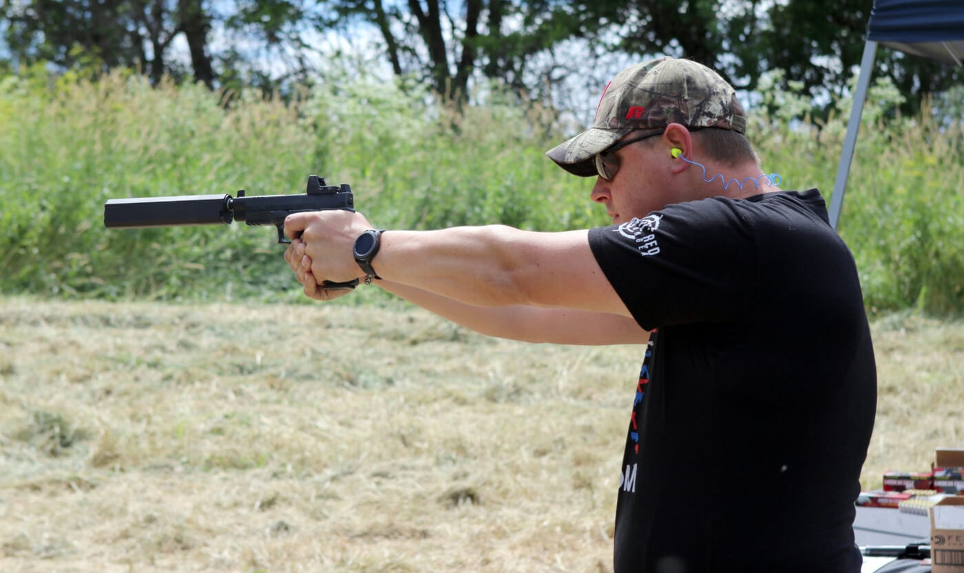 Sen. Neil Anderson shooting a suppressed pistol