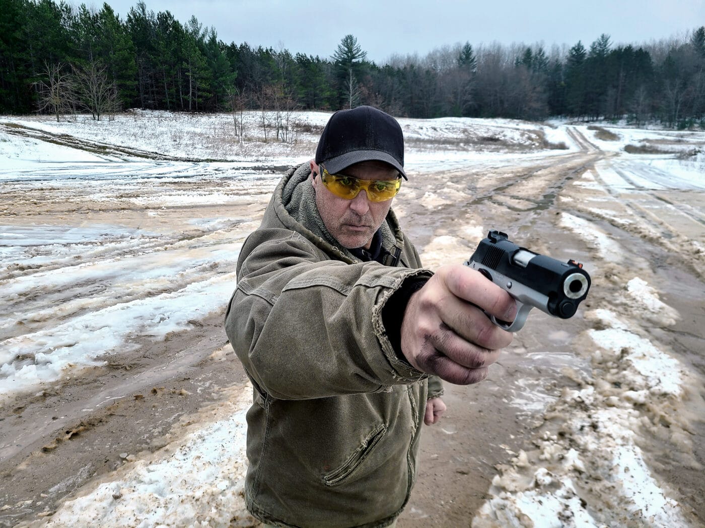 Man demonstrating canting a pistol for one handed shooting