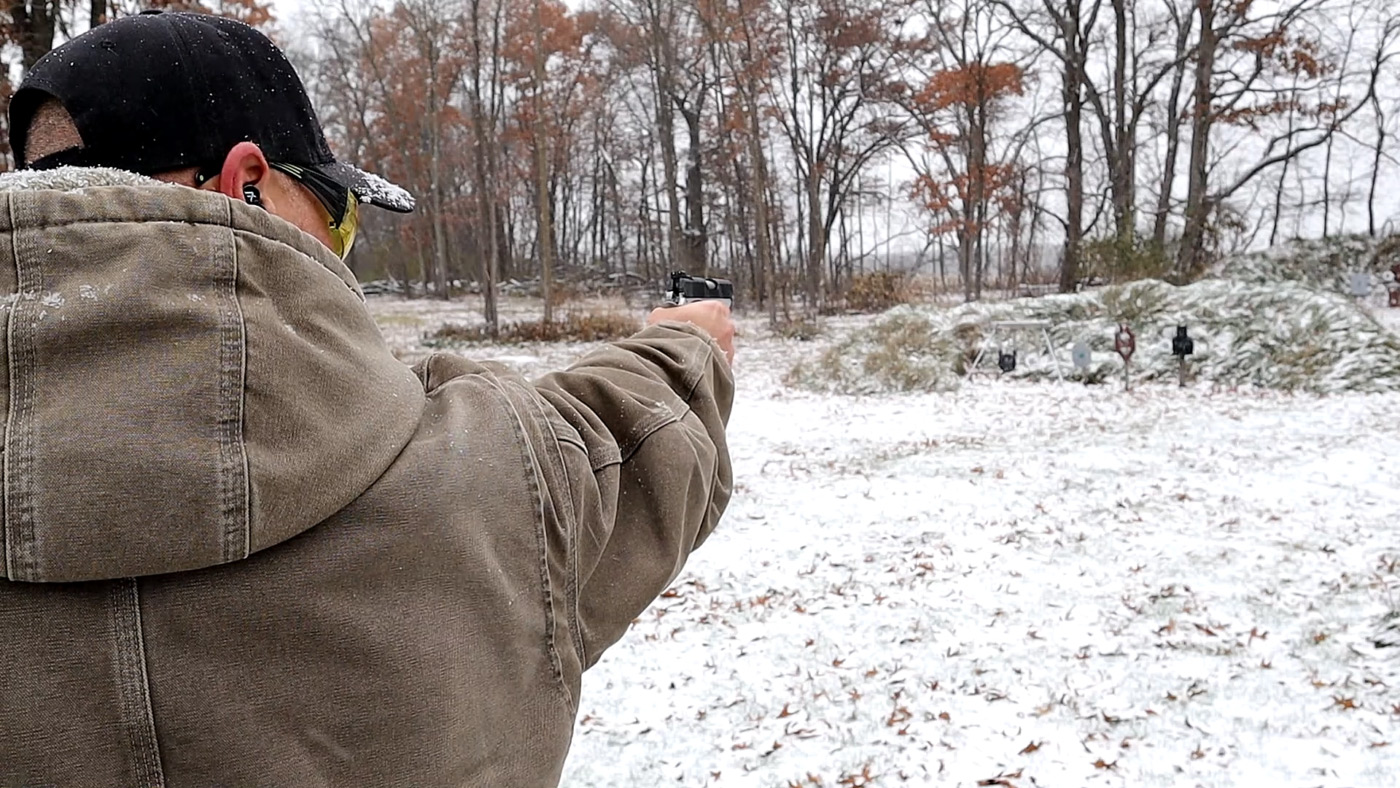 Man shooting a 1911 at 20 yards with one hand