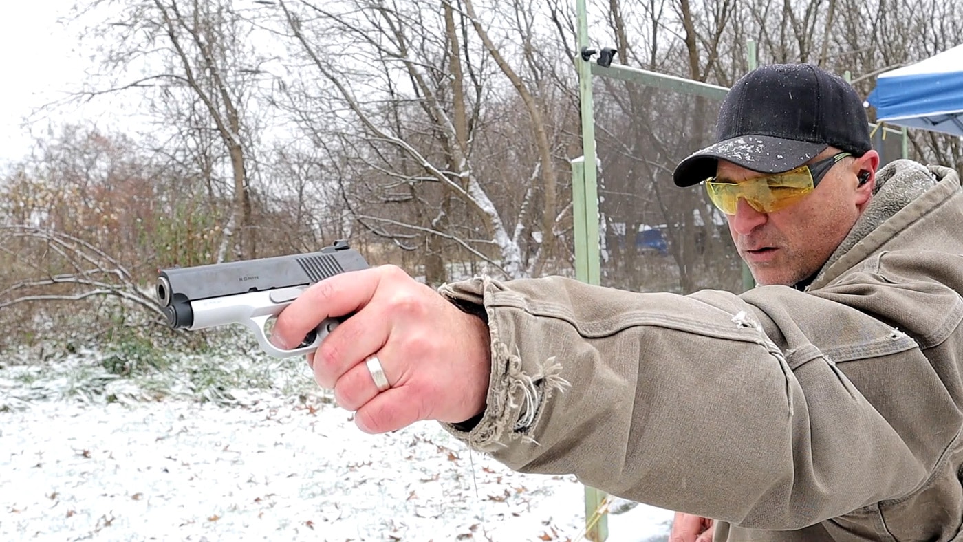 Man shooting with the off hand