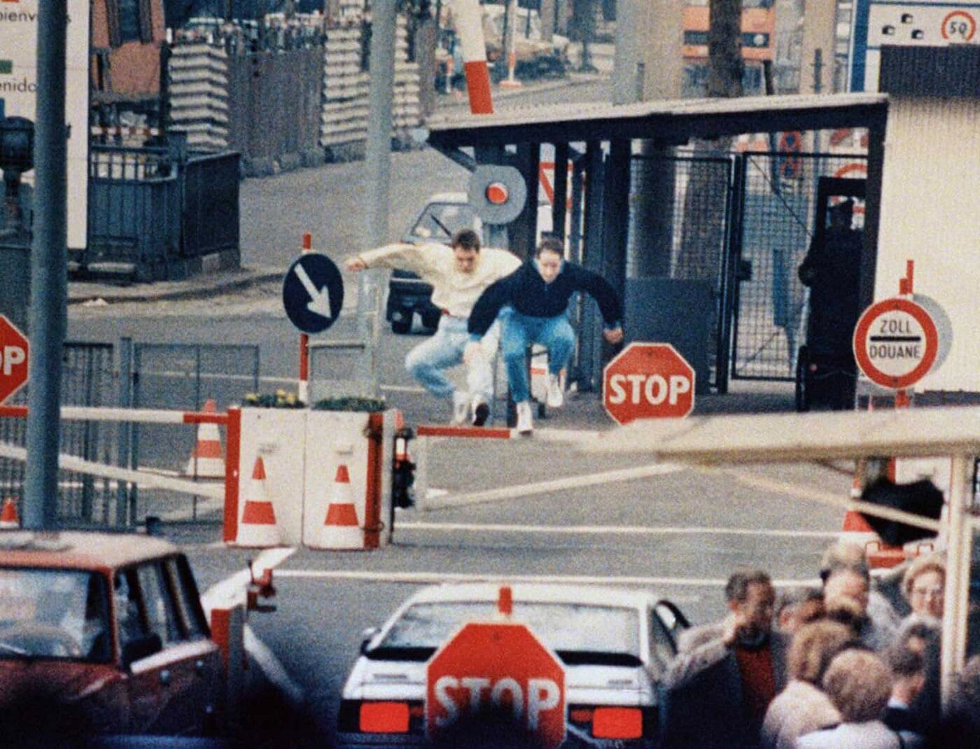 Men jumping the fence at the Berlin Wall checkpoint