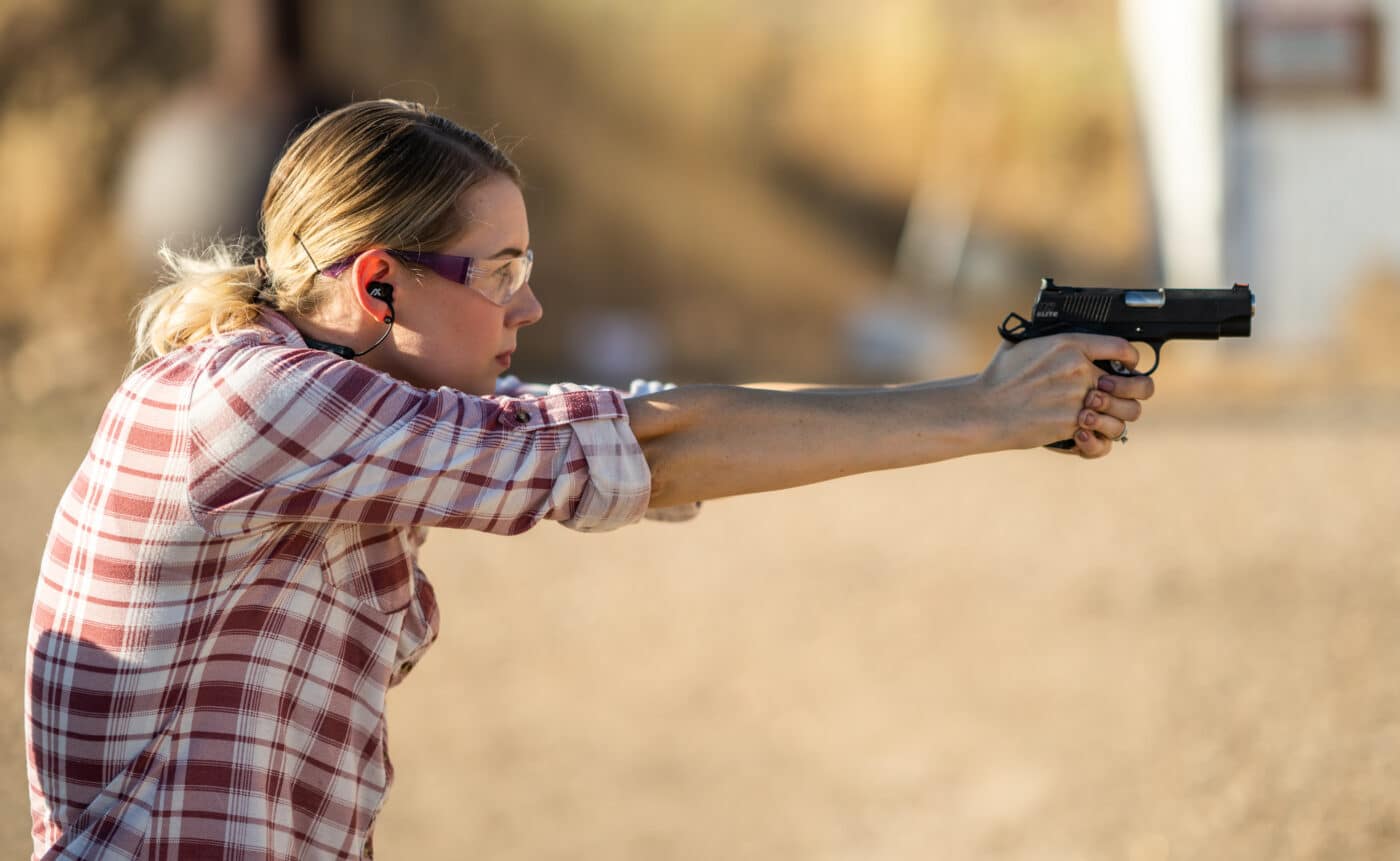 Woman demonstrating pistol shooting stance