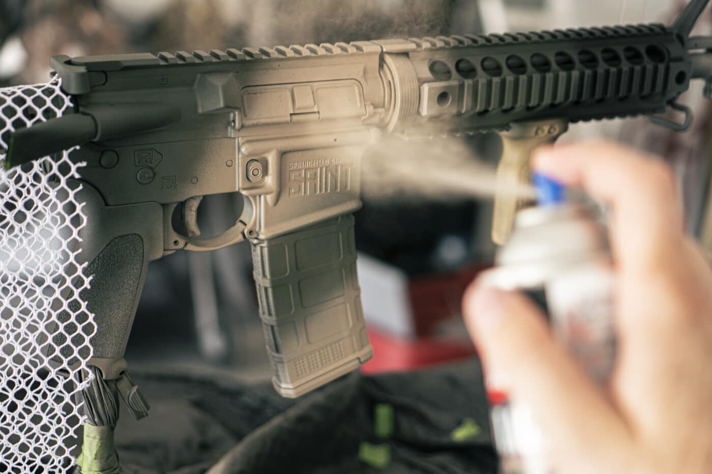 Applying spray paint to a rifle