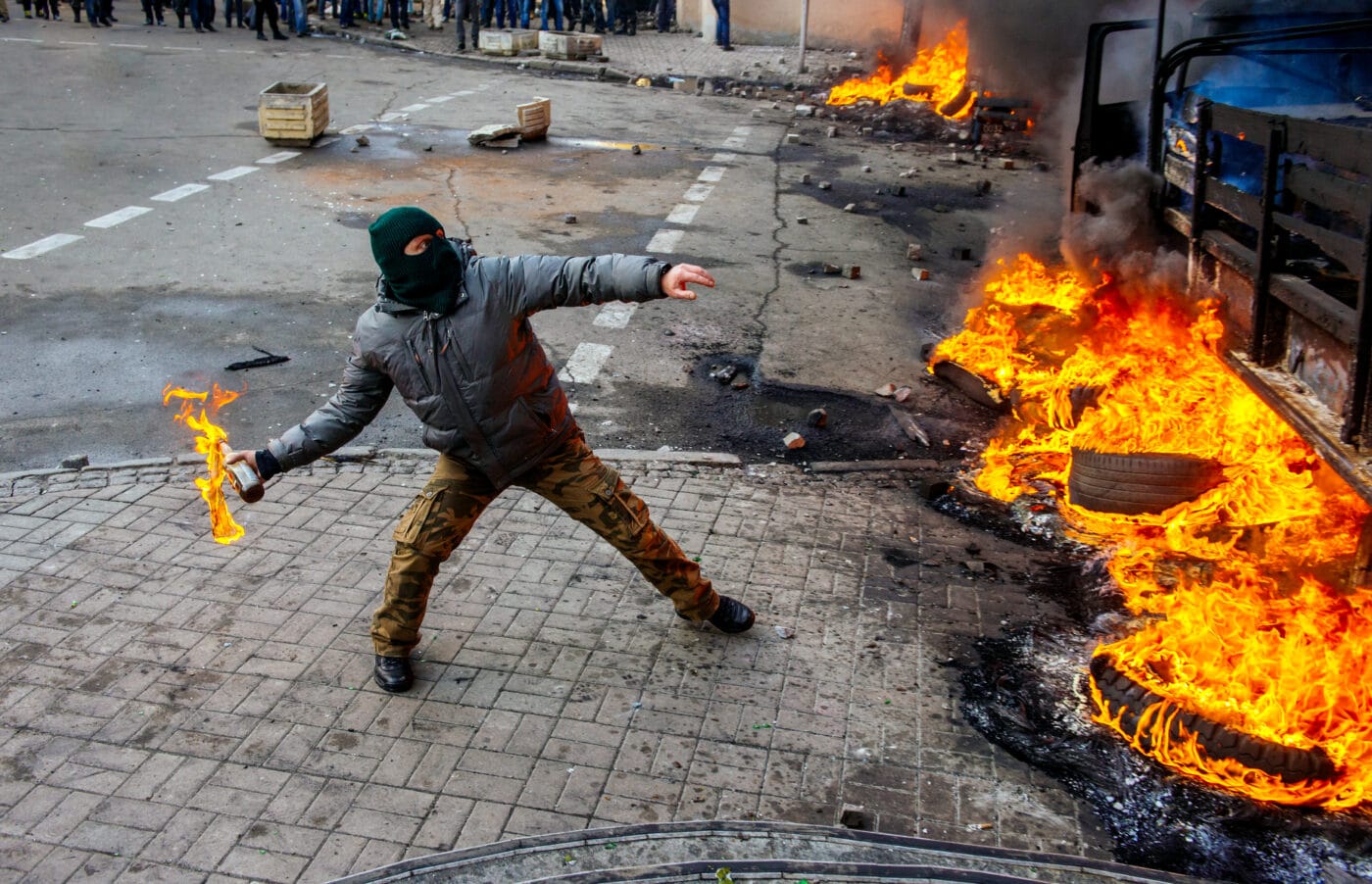 Man throwing Molotov cocktail